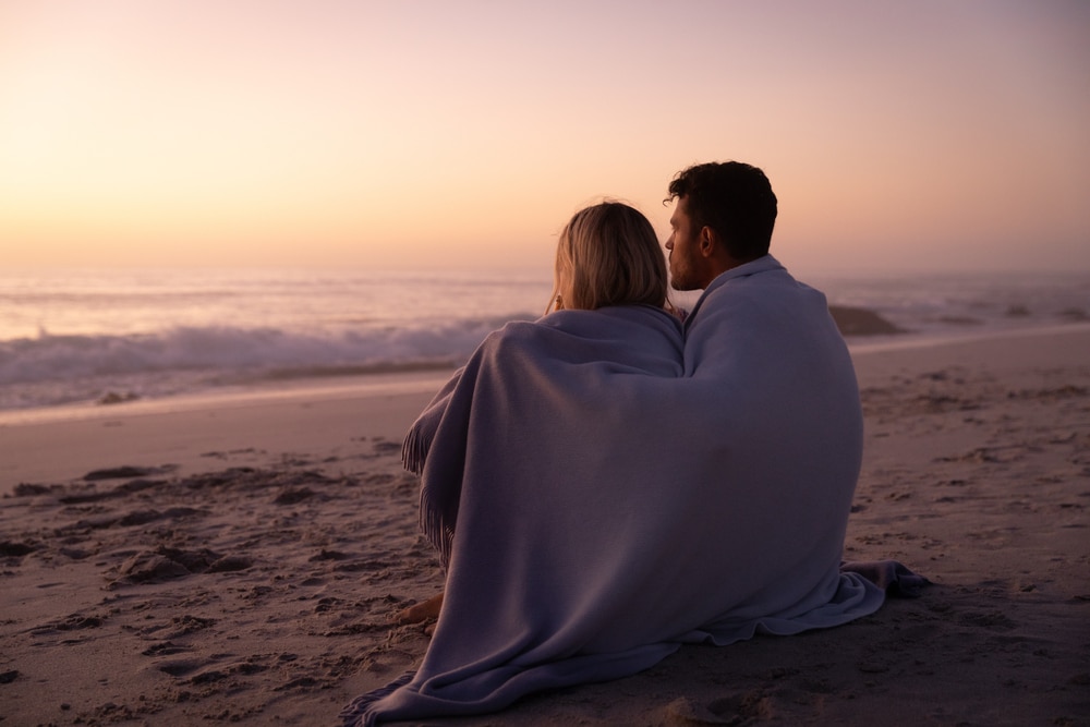 Oregon Getaways for Couples, a couple enjoying a winter beach 